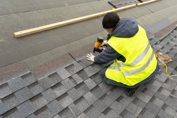 Roofing worker with nail gun in hi-vis vest